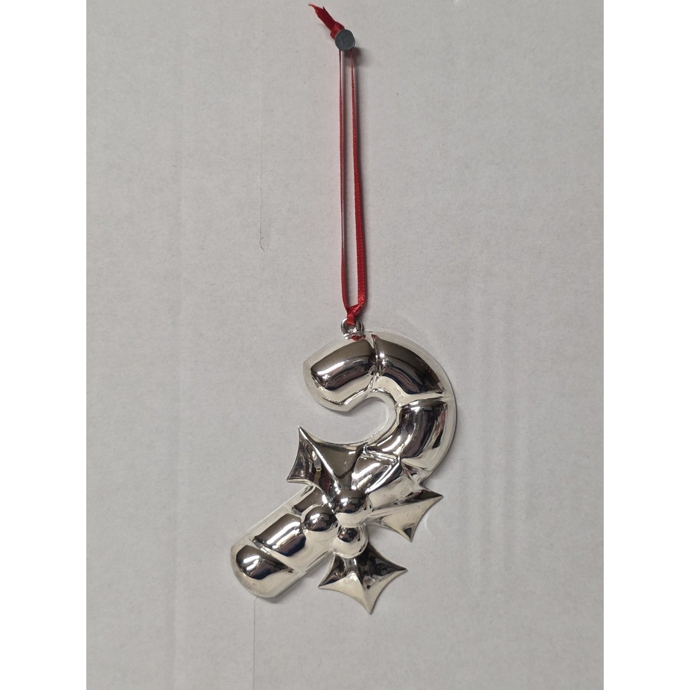 silver-plated Christmas ornament shaped like a candy cane with a holly design